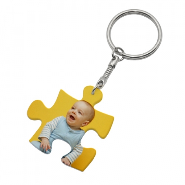 Puzzle piece as a key ring made of plastic including a personal print